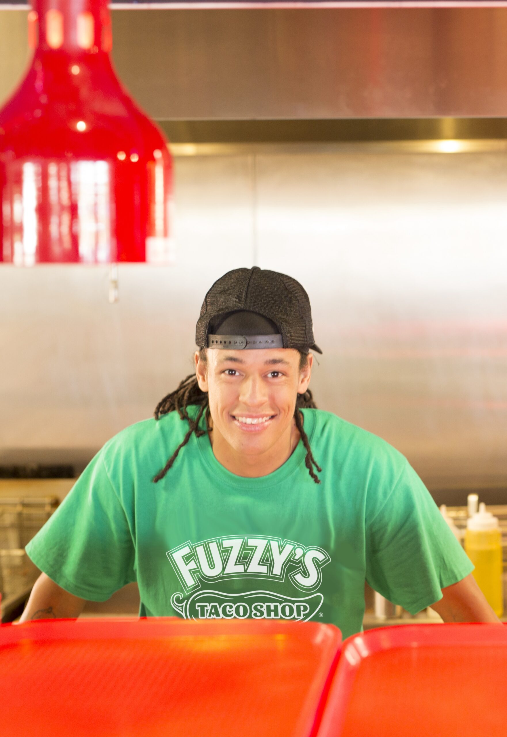 Image of a Fuzzy's employee smiling in the kitchen
